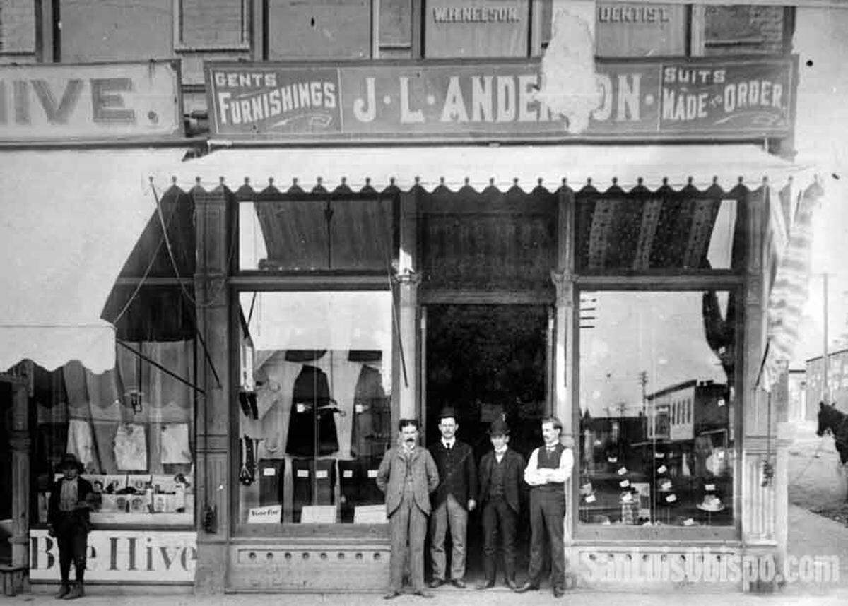 ‘GENTS’ FURNISHINGS’...J.L. “Jeff “ Anderson, standing far left, poses outside his men’s wear shop which he opened here in 1897 and operated until 1922 when he sold out and built the present day Anderson hotel. The store was located at the corner of Monterey and Morro streets where the Pacific Gas and Electric company office now stands and was “kitty-corner” from the hotel site which was once a bull-fighting ring. Photos from the J.L. “Jeff” Anderson family that ran with a big Telegram-Tribune story 7-2-1954 on his 90th birthday. He built the Anderson Hotel in San Luis Obispo and was a long time businessman in the area.