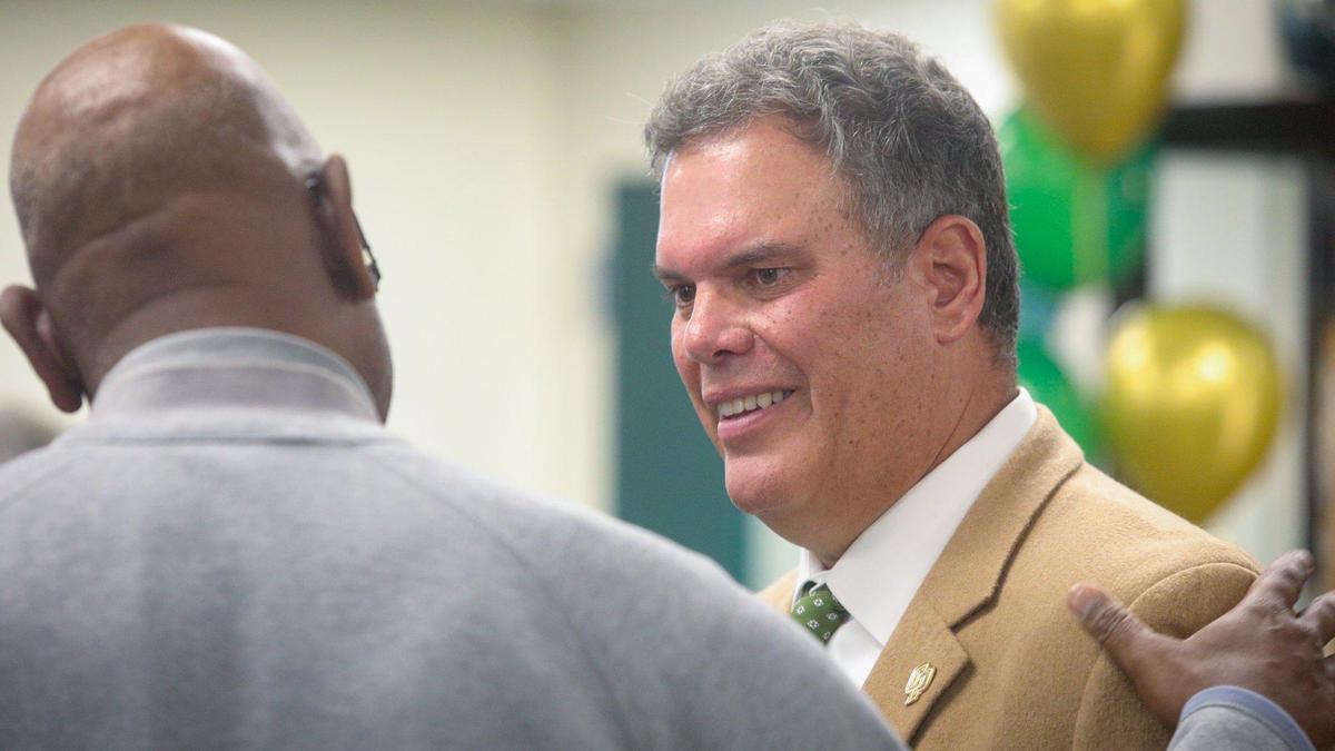 Paul Wulff was named head football coach at Cal Poly on Dec. 6, 2022. Here he is congratulated by men’s basketball head coach John Smith.