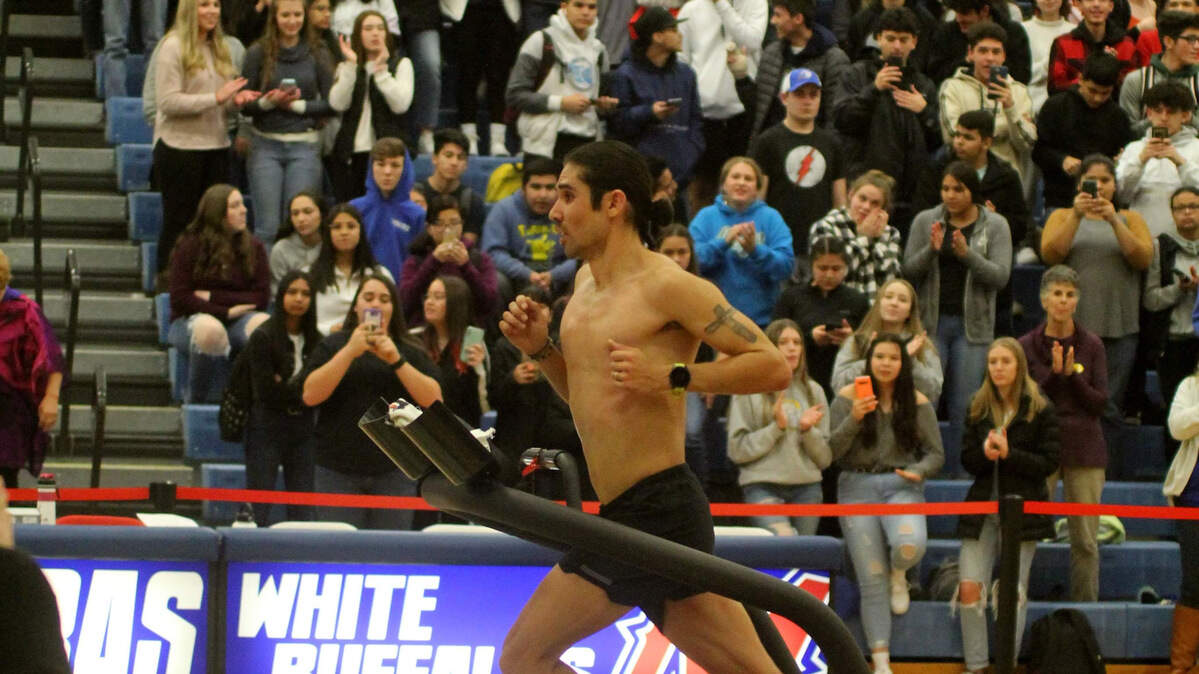 Coast Union High School graduate Mario Mendoza sets a world record running on a treadmill in front of students at Madras High School in Oregon on Jan. 14, 2020.