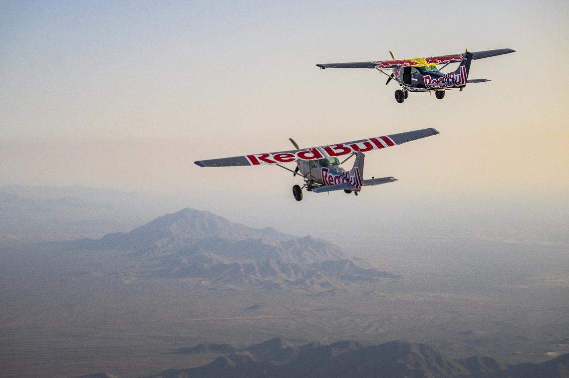 The blue and silver planes ascend to 14,000 feet before the pilots attempted a skydiving plane swap on April 24, 2022, over Arizona. the stunt was half successful with one pilot completing the swap and landing the plane while the other parachuted to safety.