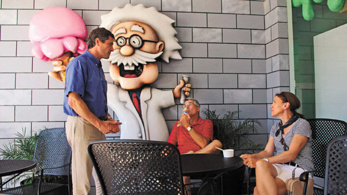 Greg Steinberger talks with customers Lisa and Paul Bialek of Seattle in front of the San Luis Obispo shop.