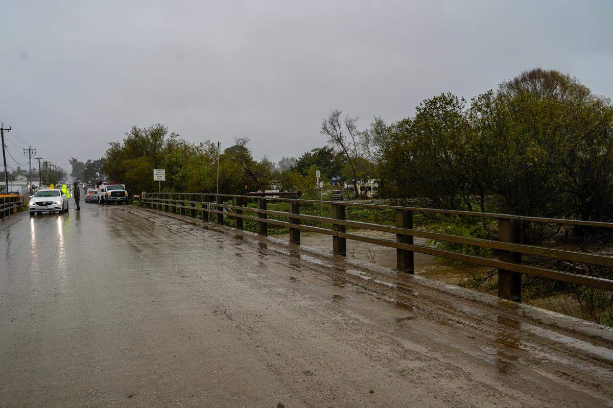 San Luis Obispo County Department of Public Works officials monitor the Arroyo Grande Creek levee’s overflow levels.