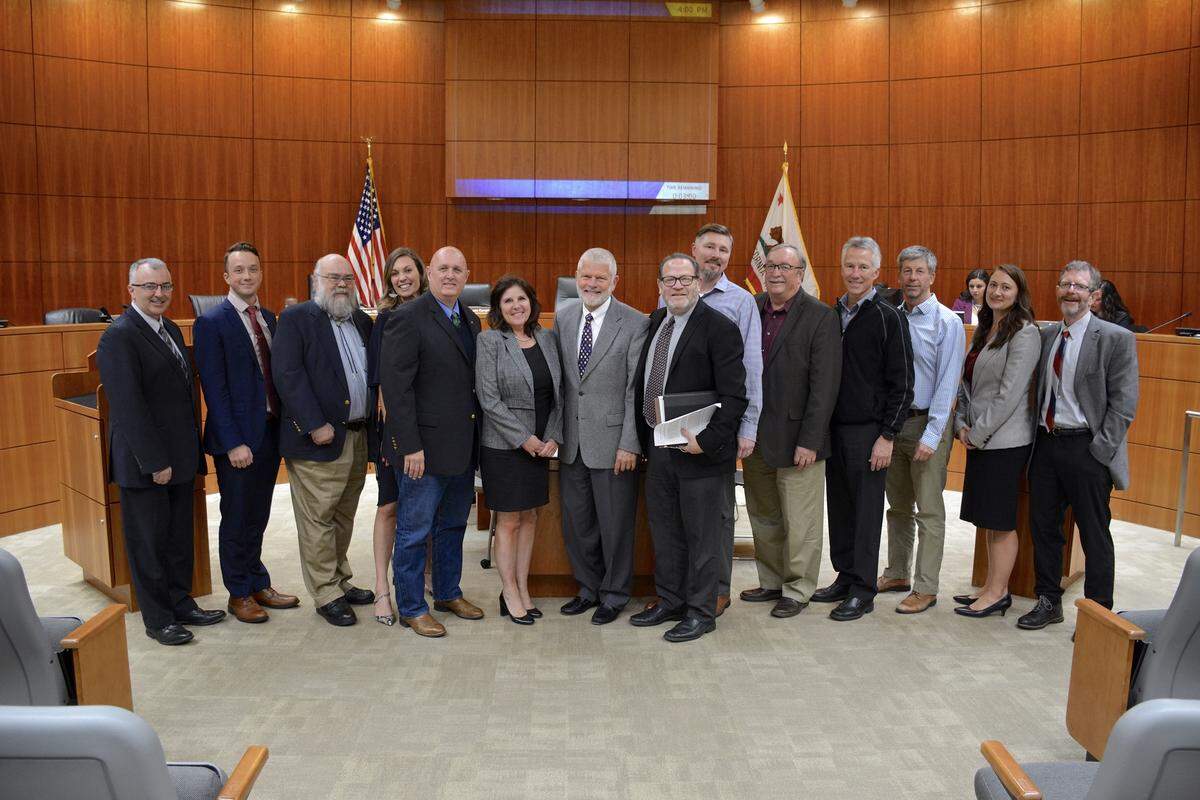 A new housing deal brought forward by a coalition of San Luis Obispo County organizations was adopted by the Board of Supervisors. Pictured, from left to right, are Ken Trigueiro, Michael Hopkins-Tucker, Jerry Rioux, Melissa James, Superviosr John Peschong, Supervisor Debbie Arnold, Supervisor Bruce Gibson, Supervisor Adam Hill, Andrew Hackleman, Davie Cooke, Brac Brechwald, Lenny Grant, Loreli Cappel and Scott Smith.