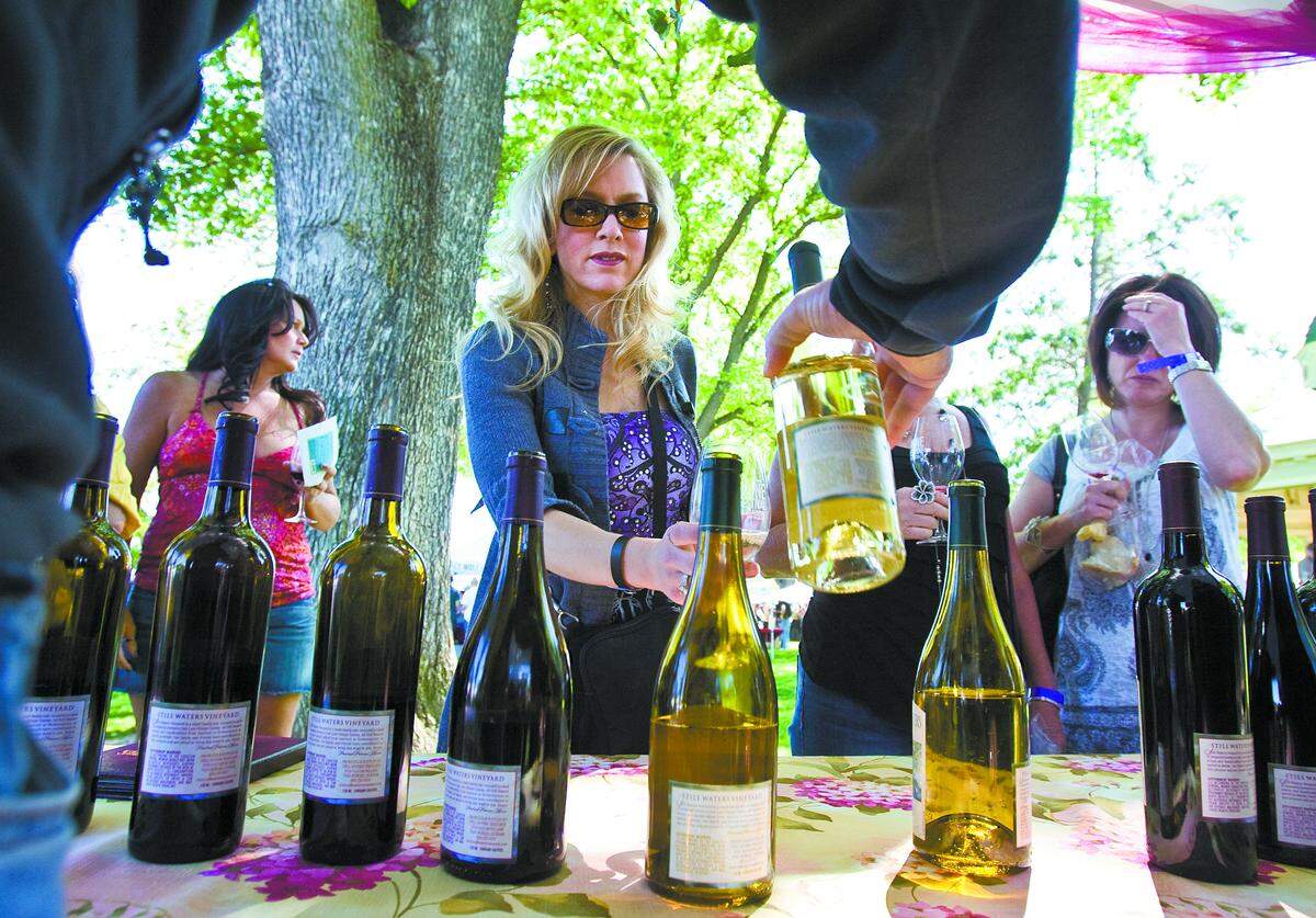 Michelle Shugart fills her glass with wine from Still Waters Vineyard at the Paso Robles Wine Festival in 2010.