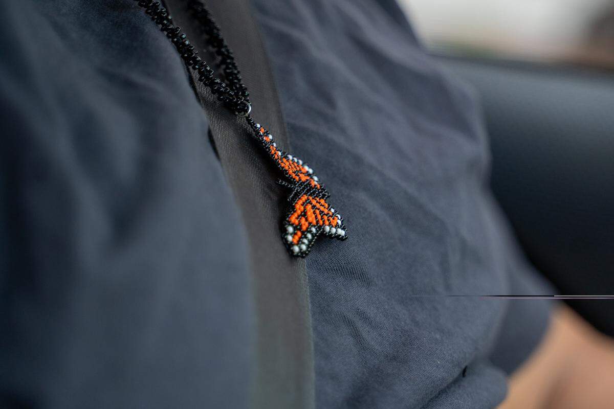 Cesar Vasquez wears a butterfly necklace while patrolling for ICE in Santa Maria on Saturday, Sept. 20, 2025.