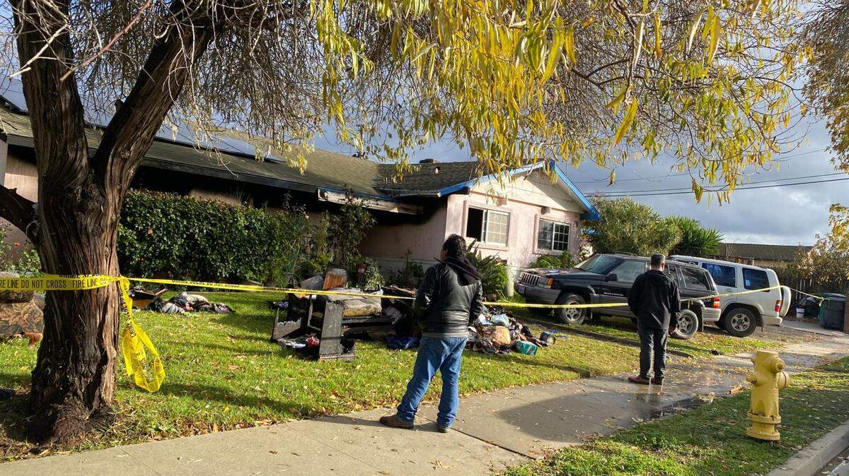 Caution tape surrounds a house in Tanglewood, west of Santa Maria, where a fire killed two women Sunday night and sent a man to the hospital with burn injuries.