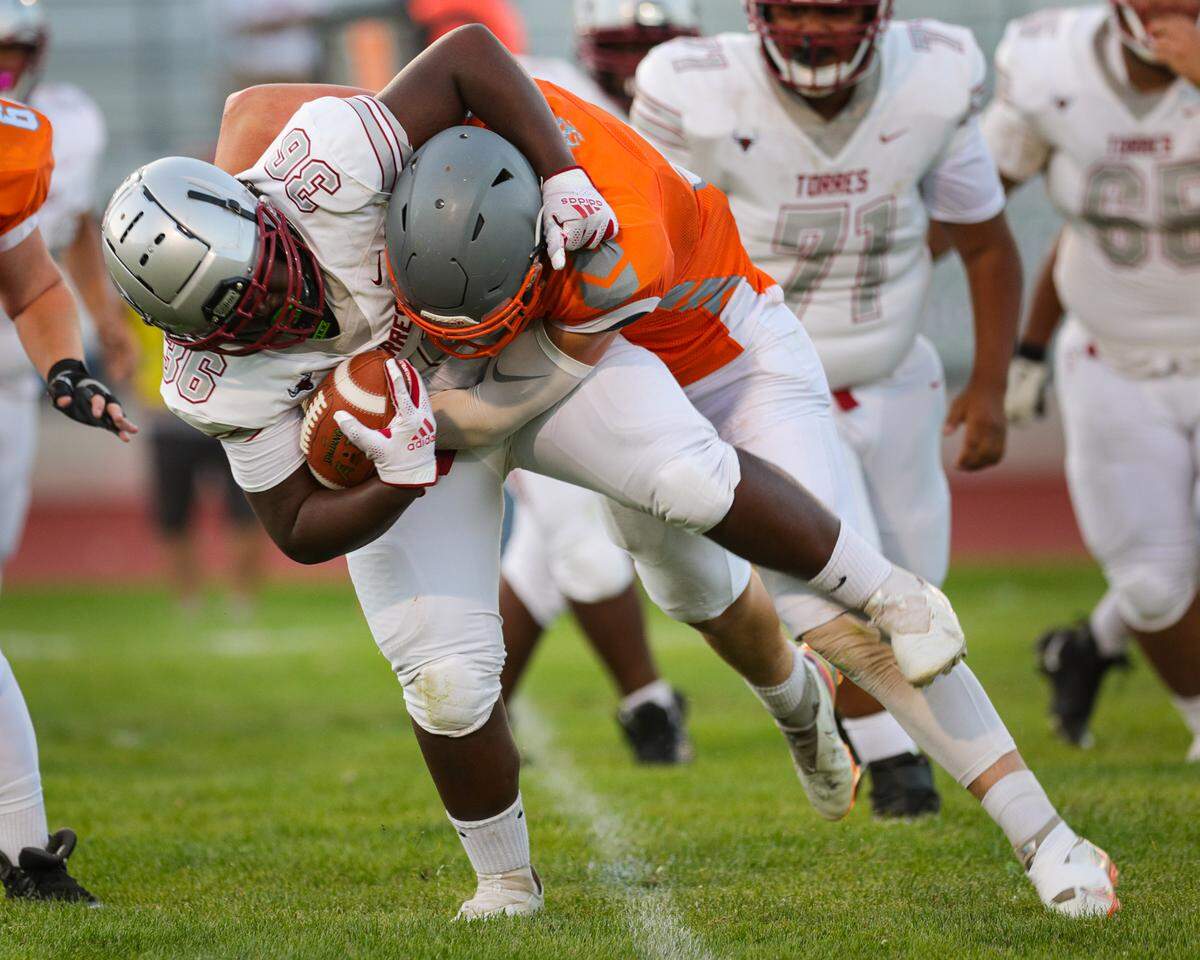 Dallas Parish tackles Tyrese Hayward. Atascadero hosted Torres of Madera to open the football season with a non-league matchup.