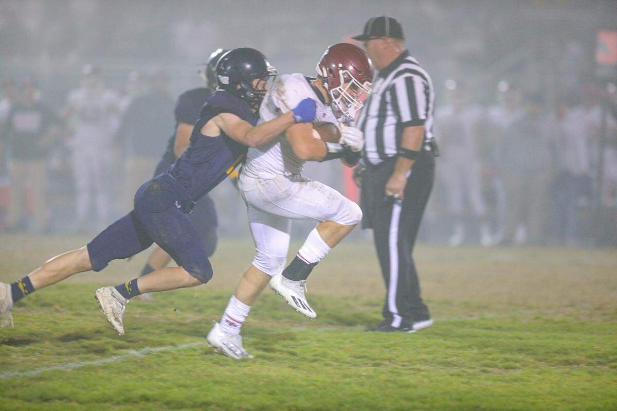 Koa Kopcho brings down Jake Morones.Arroyo Grande hosted Paso Robles to decide the football league title.