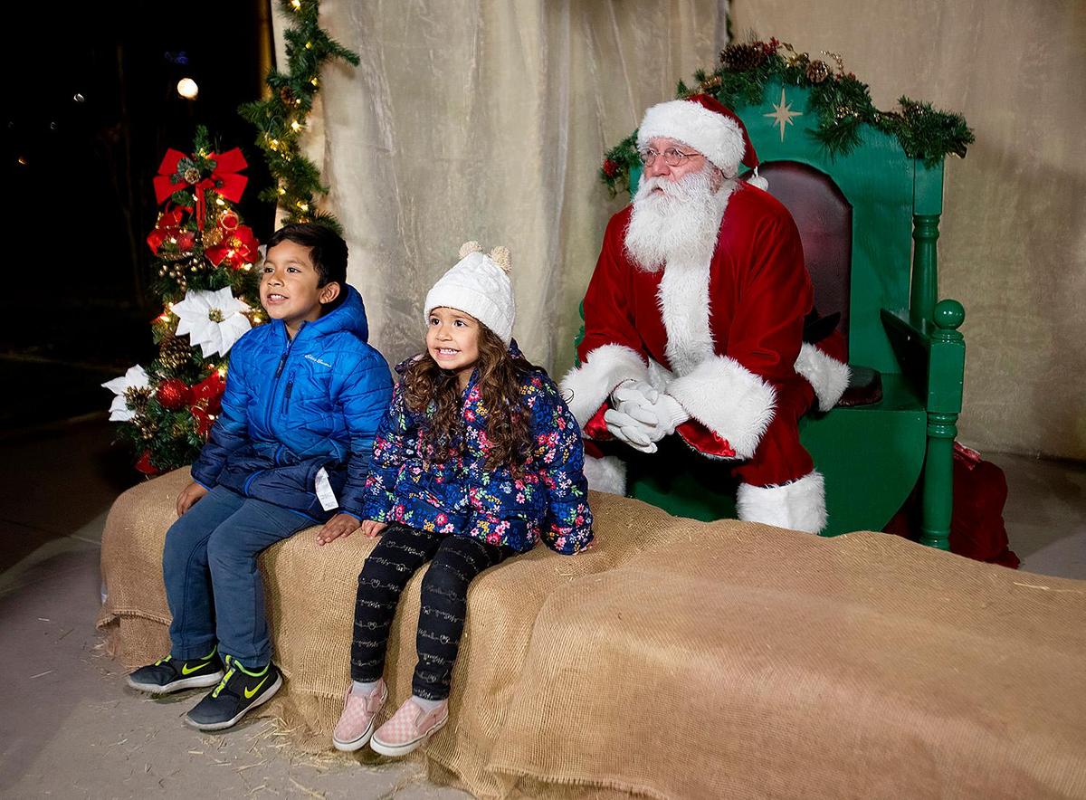Ryan Cuellar, 6, and his sister Emily, 3, of Paso Robles get a photo with Santa Claus. Hundreds of people showed up for the Atascadero Winter Wonderland night for snowball fights, tasty food, fun games and, of course, to visit Santa Claus.