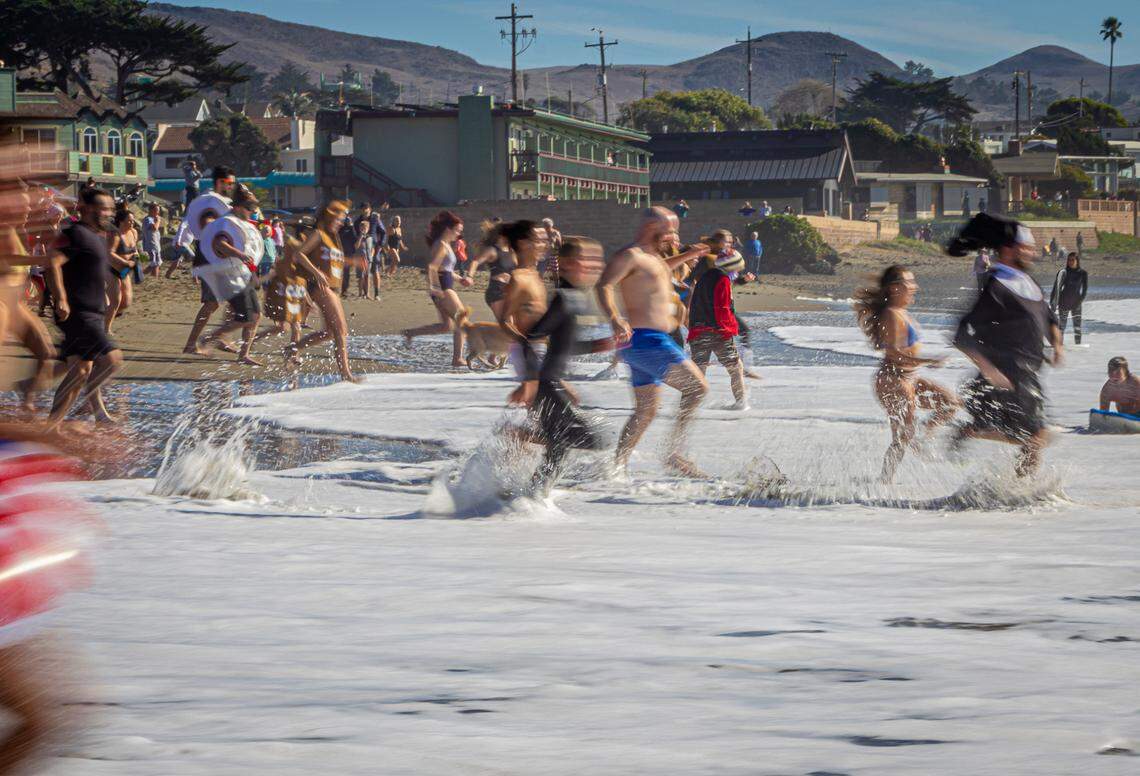 More than 200 people turned out Friday in Cayucos for an unofficial New Year’s Day polar bear dip. The official event was canceled due to the COVID-19 pandemic.