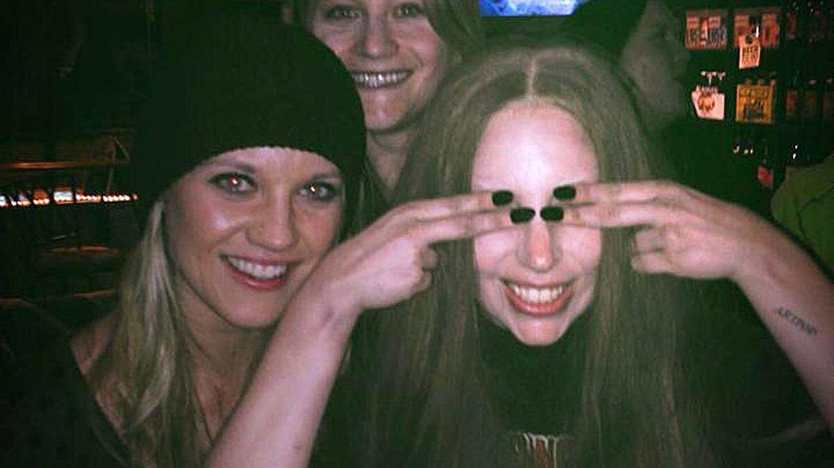 Lady Gaga playfully covers her eyes for a snapshot at the Cambria Ale House on Thursday, Feb. 13, where she and a couple dozen video crew members spent a couple hours drinking and dancing. Pictured with Gaga are two Cambria Grammar School teachers, Marissa Conway (in black cap) and Laura Loegering. The tattoo on Gaga's left arm says "Artpop," the name of one of her albums.