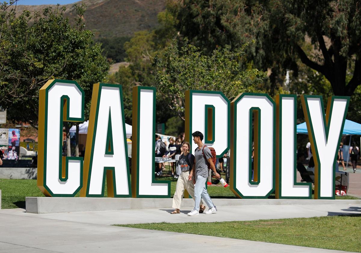 Students walk past the Cal Poly sign in the University Union on Sept. 24, 2024.