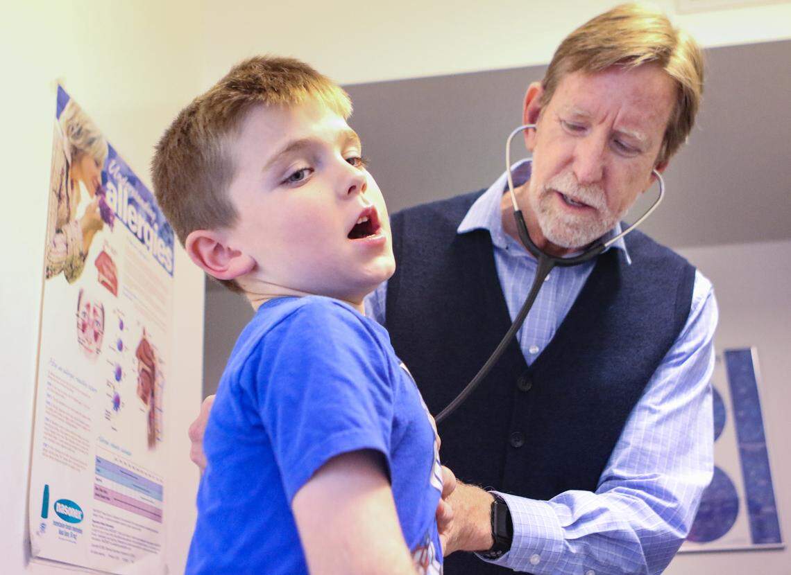 Dr. William Morgan, a pediatrician in Arroyo Grande, asks Kagan Stump to take a deep breath as he listens with a stethoscope.