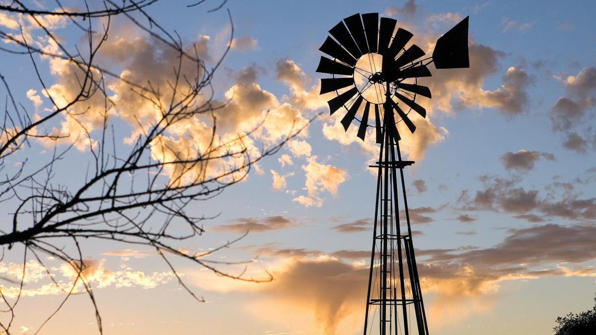 A windmill stands against incoming clouds and sunset along Highway 41 between Creston and Atascadero on Nov. 10, 2013.