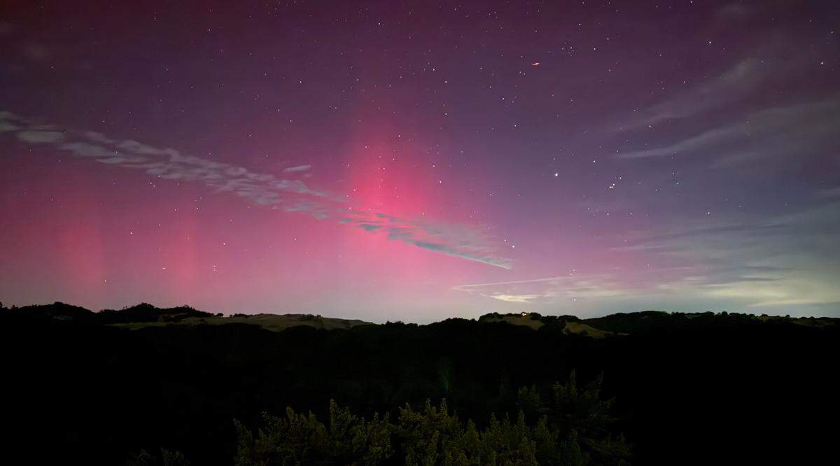 The northern lights illuminate the sky above Highway 46 West near Cambria on Oct. 10, 2024.