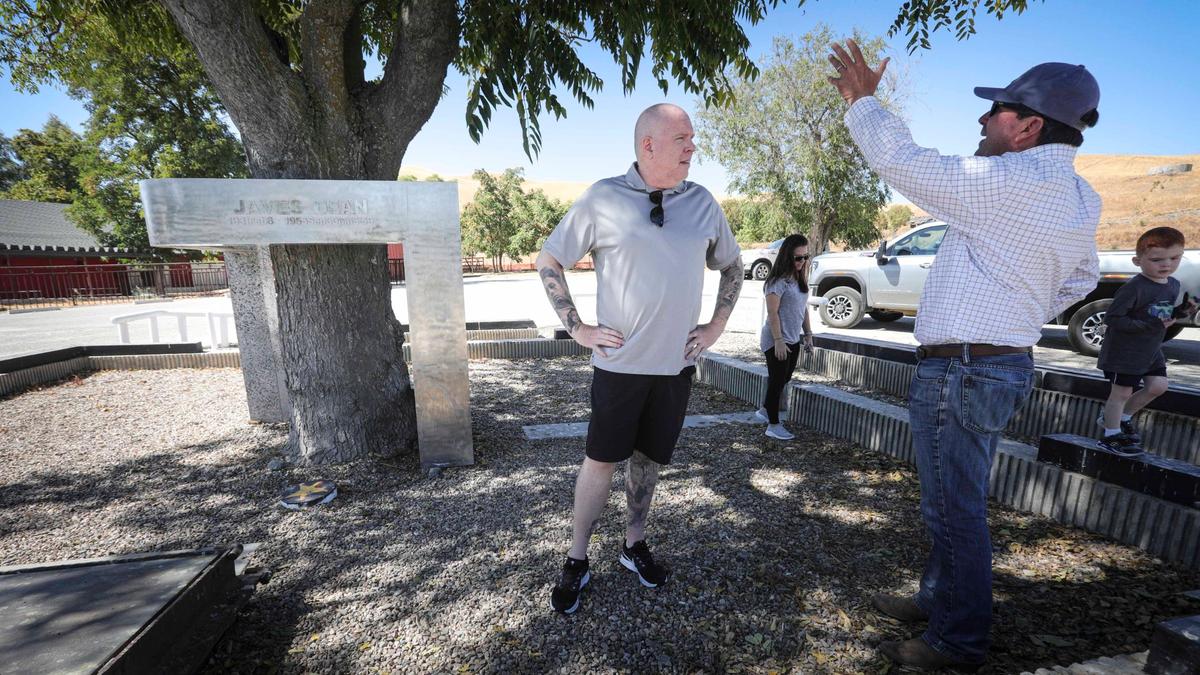 James Dean memorabilia collector Neil Sheehan at left, is organizing an effort to restore the 1977 memorial to the famed movie star who died east of Cholame in a 1955 car wreck. He talks to Ben Higgins director of agricultural operations at Hearst Corp which owns the Jack Ranch property around Cholame.