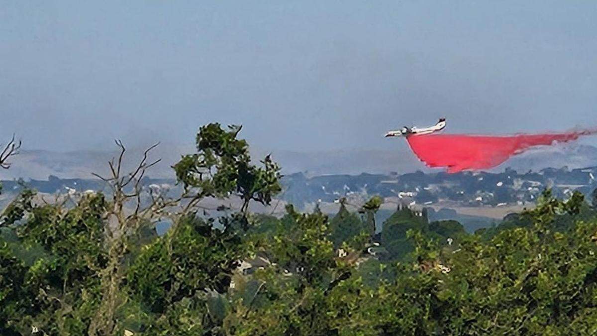 An air tanker drops fire retardant on the vegetation fire near Golden Hill Road and Ardmore Road in Paso Robles on Wednesday, May 20, 2026.