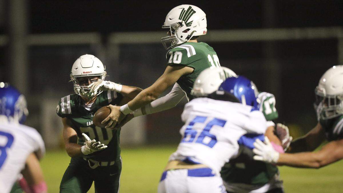 Colter Tannehill hands off to Tyler Cunningham. Templeton beat Morro Bay 56-14 in football game seen here on Oct. 9, 2025.