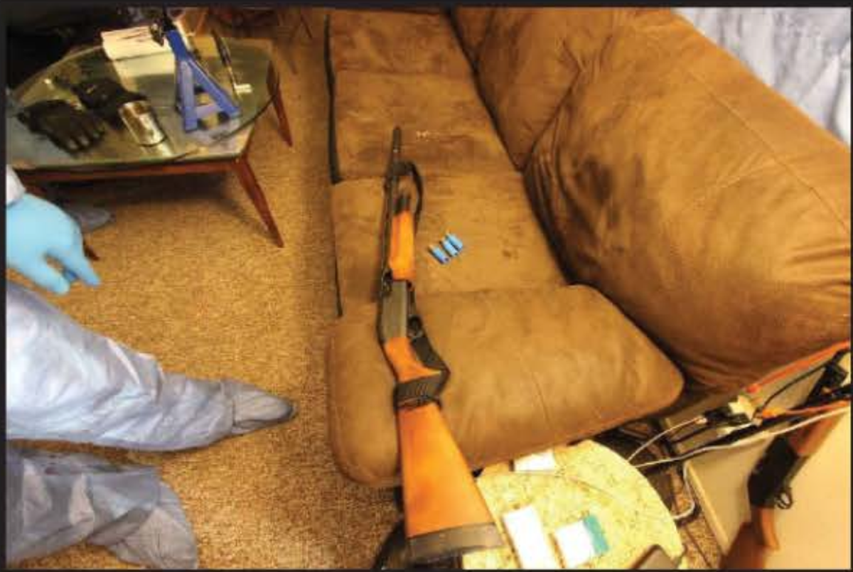 A Remington 870 12-gauge shotgun found on the couch is believed to be the gun Edward Giron used to kill Det. Luca Benedetti. a Crossman Pumpmaster .177-caliber pellet gun was also found leaning against the couch next to the front door.