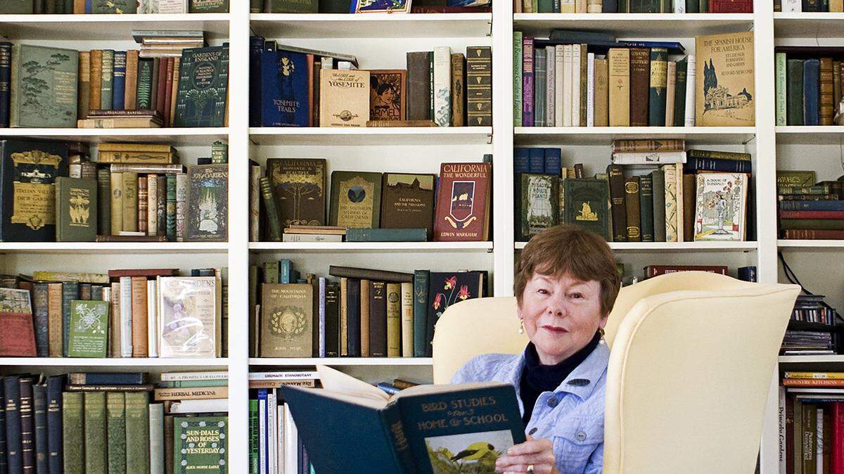 Sharon Lovejoy sits in front of her collection of vintage gardening books at her San Luis Obispo home.