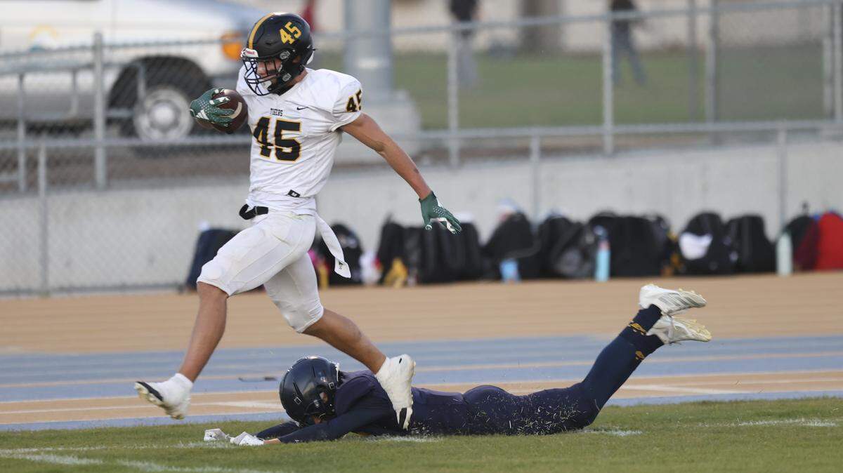 Colbin Garrison runs for a touchdown as Anders Winter tries to trip him up. Arroyo Grande beat San Luis Obispo 42-28 in a high school football game on Sept. 5, 2025.