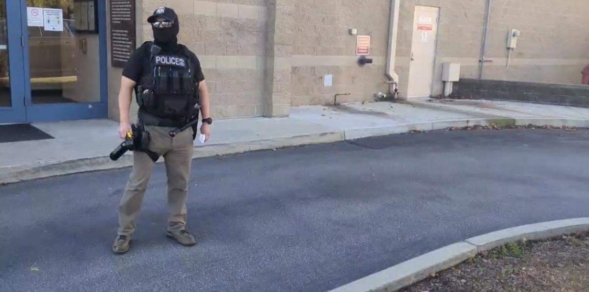 An ICE agent carried bear spray while taking two people into custody from the San Luis Obispo County Jail lobby on Nov. 25, 2025.