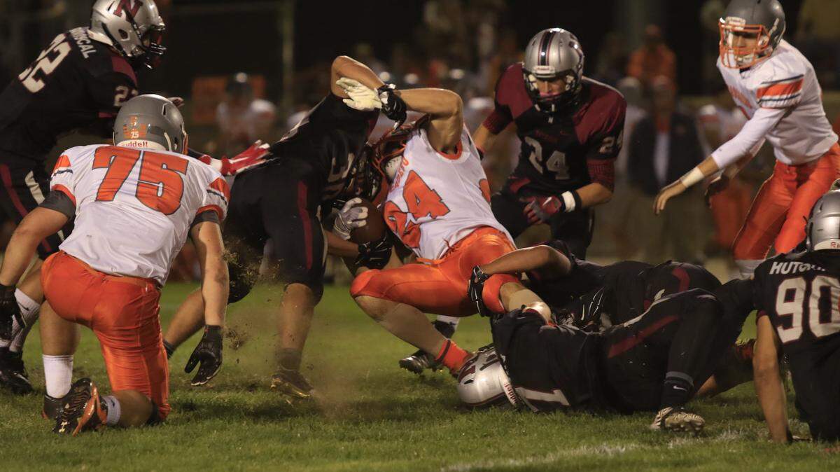 Nipomo High's Terry Wambolt tackles Atascadero running back RJ Reusche during Friday night's game.