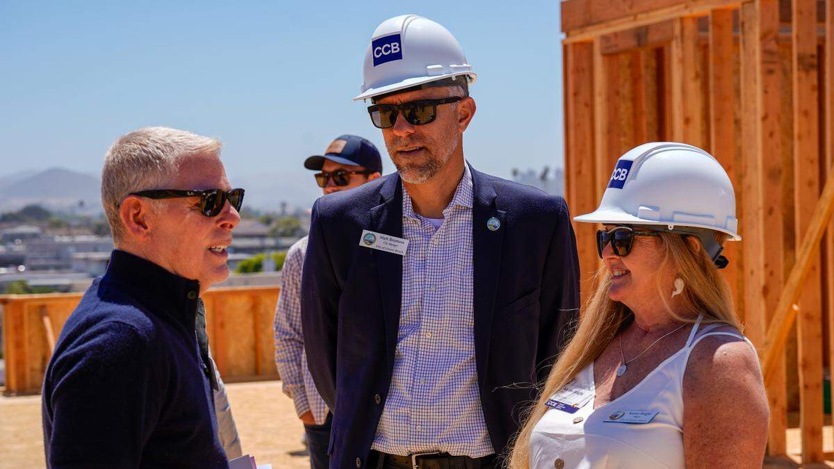 Coastal Community Builders president Gary Grossman speaks to Grover Beach Mayor Karen Bright and city manager Matt Bronson on the top deck of the “Palladium” mixed-use condo project on West Grand Avenue following the groundbreaking ceremony for “Encore,” another mixed-use condo complex, Thursday, June 27, 2024. The projects are located at the end of streetscape improvements currently in progress starting at the intersection of West Grand Avenue and 4th Street.