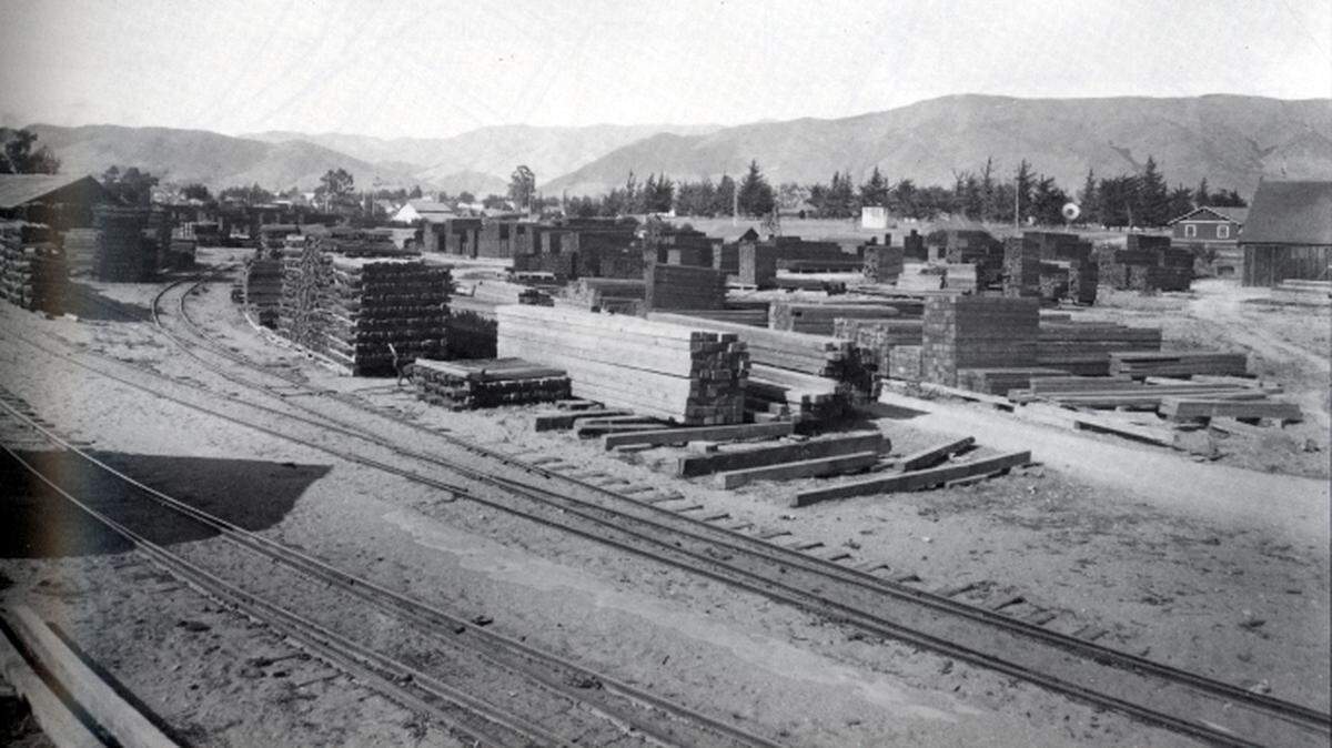 Newly arrived lumber at Pacific Coast Coal Company Lumberyard across from the Pacific Coast Railroad Warehouse at near the present intersection of Madonna Road and Higuera Street, circa 1911-12.
