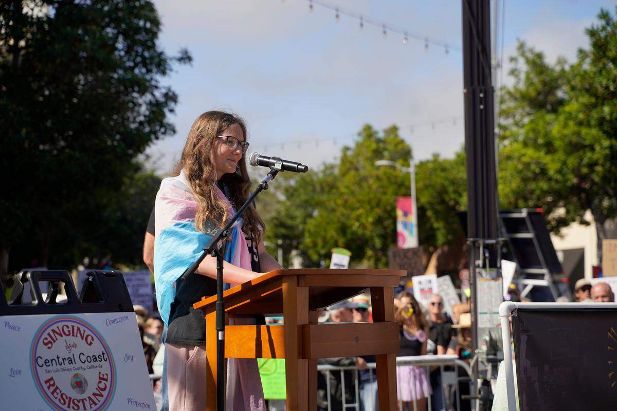 Residents across SLO County rallied downtown at the San Luis Obispo Superior Courthouse for a No Kings protest featuring speakers, music and community groups on March 28, 2026. Arroyo Grande High School student Lily Norcross speaks about trans rights.