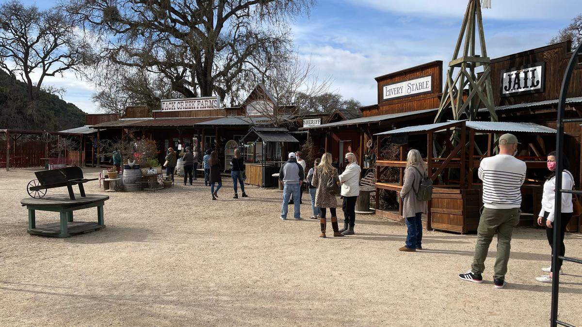 Customers lined up outside Jack Creek Farms for their closing sale. The Barlogio family-owned store is closing temporarily until tourism reopens in the area.