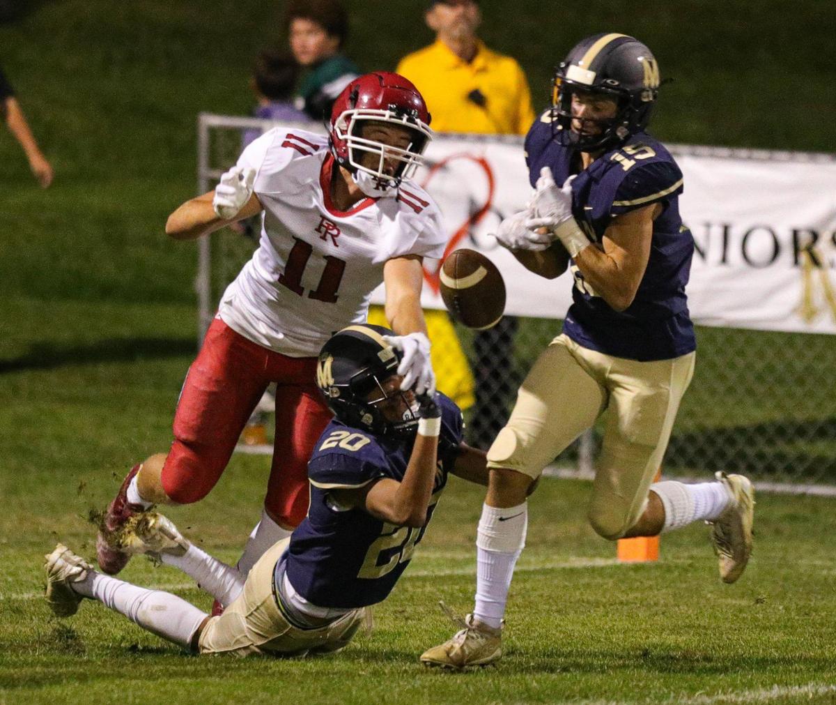 A pass intended for Tristen Salgado of Paso Robles is broken up by Jayden Nozil, left, and Luke Terry, right. Mission Prep defeated Paso Robles 28-7 in a football game on Sept. 30, 2022, in San Luis Obispo.