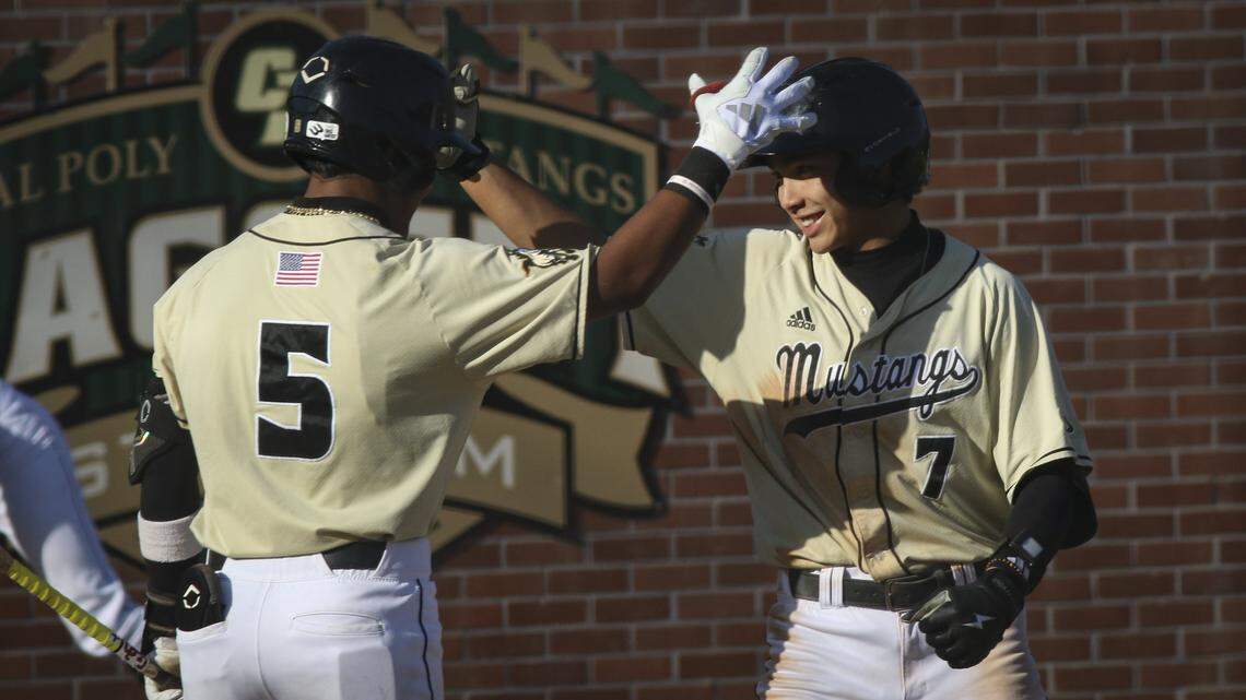 Alejandro Garza, left, congratulates Nate Castellon's home run. Cal Poly shut out Santa Clara 7-0 in a baseball game on April 28, 2026.
