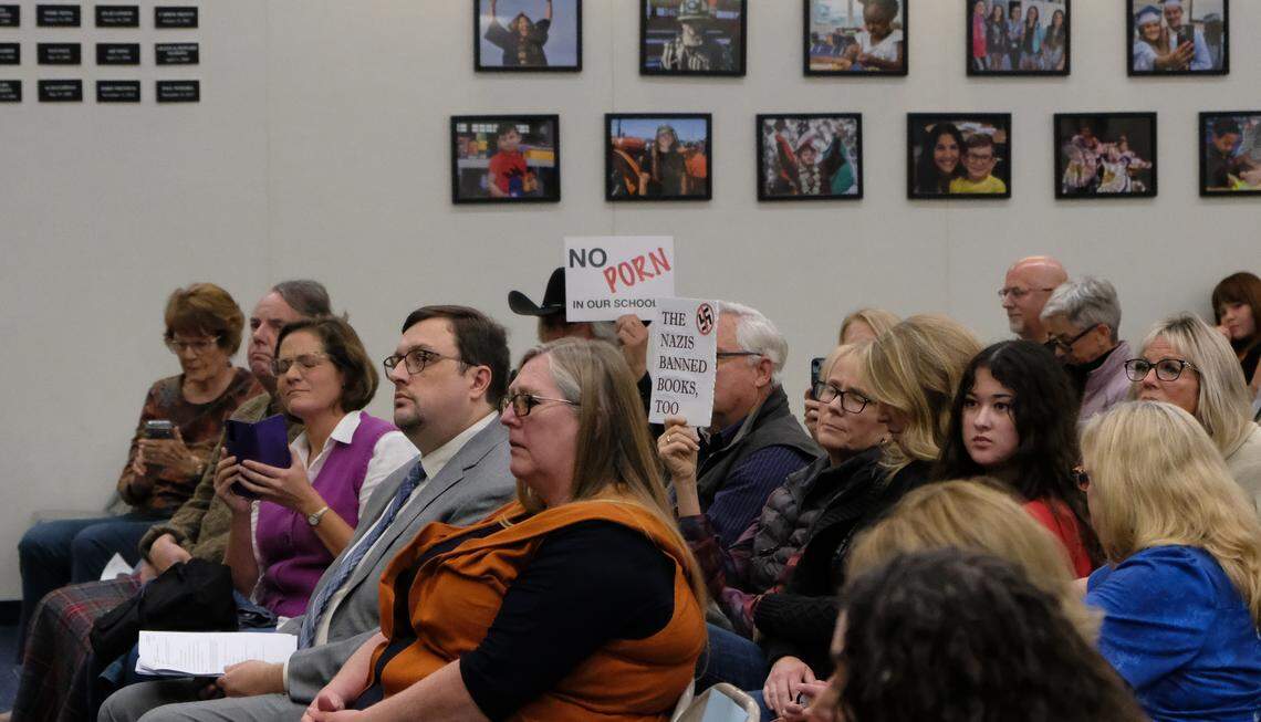 Community members hold signs at a Lucia Mar school board meeting on Nov. 18, 2025, where the books “Gender Queer” and “Push” came under fire. The school board voted to keep the books in the Arroyo Grande High School library.