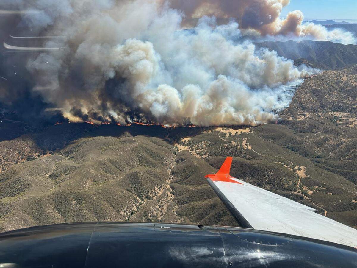 An air tanker flies over the Gifford Fire on Wednesday, Aug. 6, 2025.
