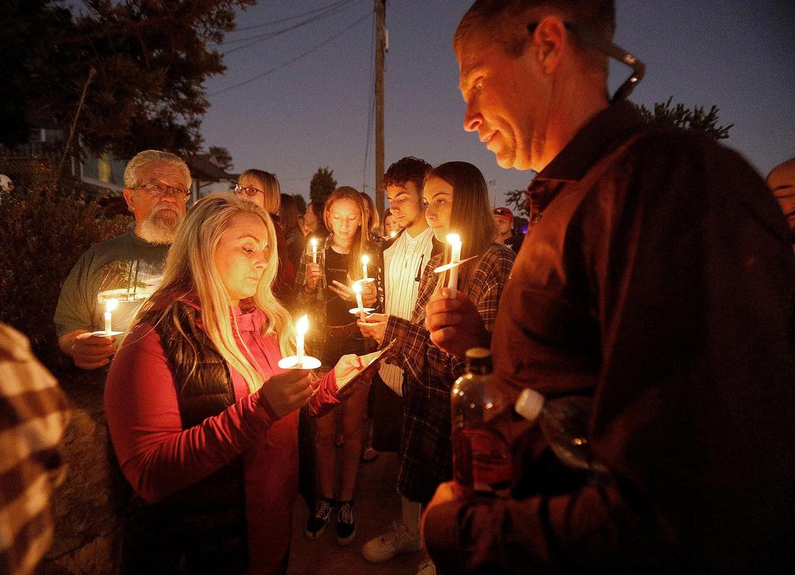 More than 250 supporters attend a candlelight vigil for Kristin Smart in front of Paul Flores’ family home in Arroyo Grande on Sunday, Nov. 17. Marie Inman, center, and her husband Chuck Inman, right, read the Lord’s Prayer to the crowd in front of the Flores family home.