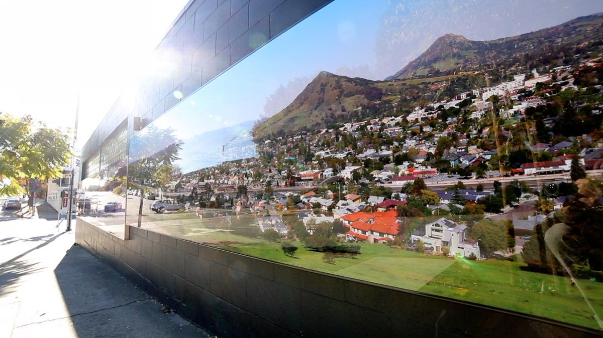 Two murals of San Luis Obispo are on the corner of Johnson and Monterey Streets, Jan., 4, 2022. Frank Aston made the black and white photo in 1930 showing steam engines and hay being harvested. Brian Lawler made the new digital image by stitching together 1,694 images and using a 60-foot lift to recreate the viewpoint that was mined away in the 1940s to build freeway.