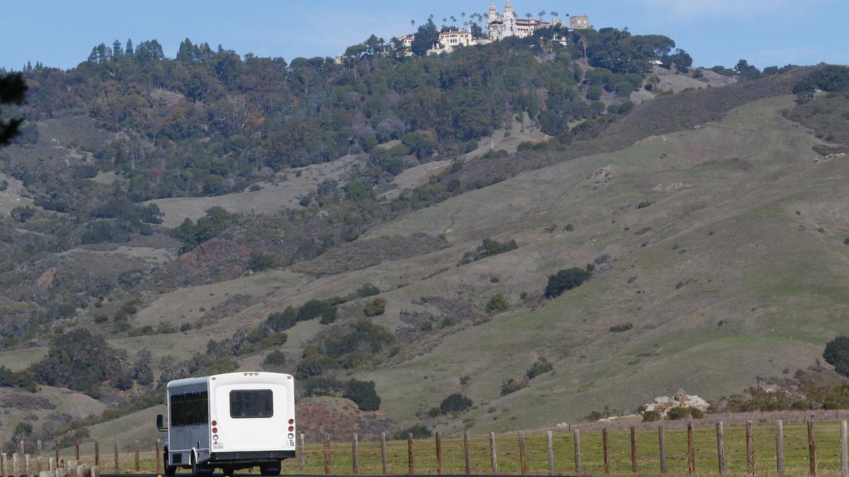 A Laz Parking bus heads out Tuesday from the Hearst Castle Visitor Center toward the hilltop in December 2018. Construction crews are making progress on access road repairs.