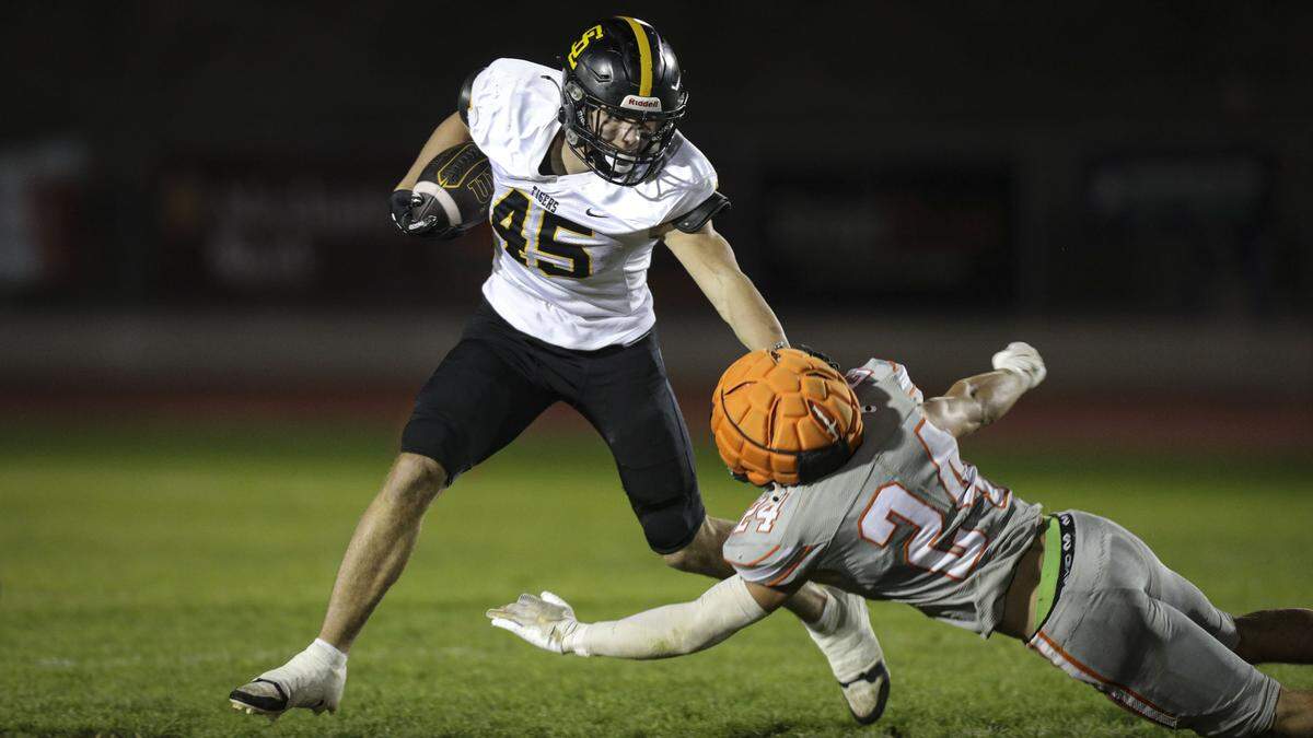 Colbin Garrison got steady yardage throughout the game, Damon Mitchell reaches to tackle.  San Luis Obispo beat Atascadero 28-14 in high school football on Oct. 31, 2025.