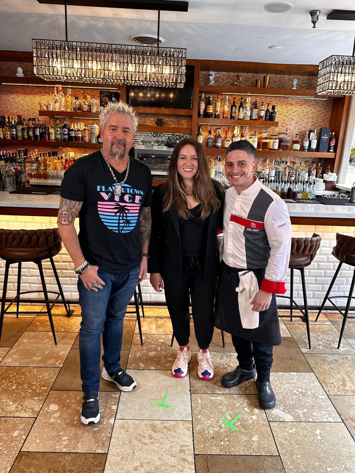 “Diners, Drive-ins and Dives” host Guy Fieri poses for a photo with Flour House owners Gessica and Alberto Russo. The downtown San Luis Obispo restaurant was featured on the show’s 40th season.