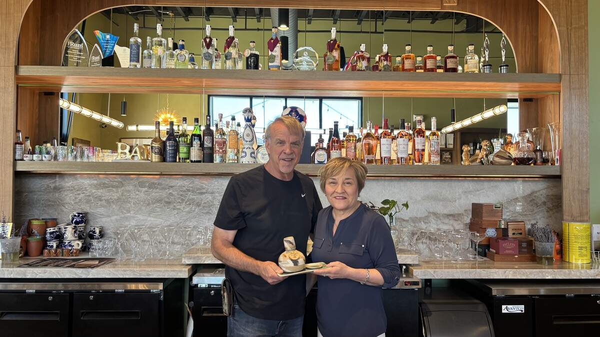 Co-owners of Central Coast Distillery in Atascadero Eric and Anna Olson stand behind the distillery’s bar with their famous agave mezcal, seen here on July 2, 2026.