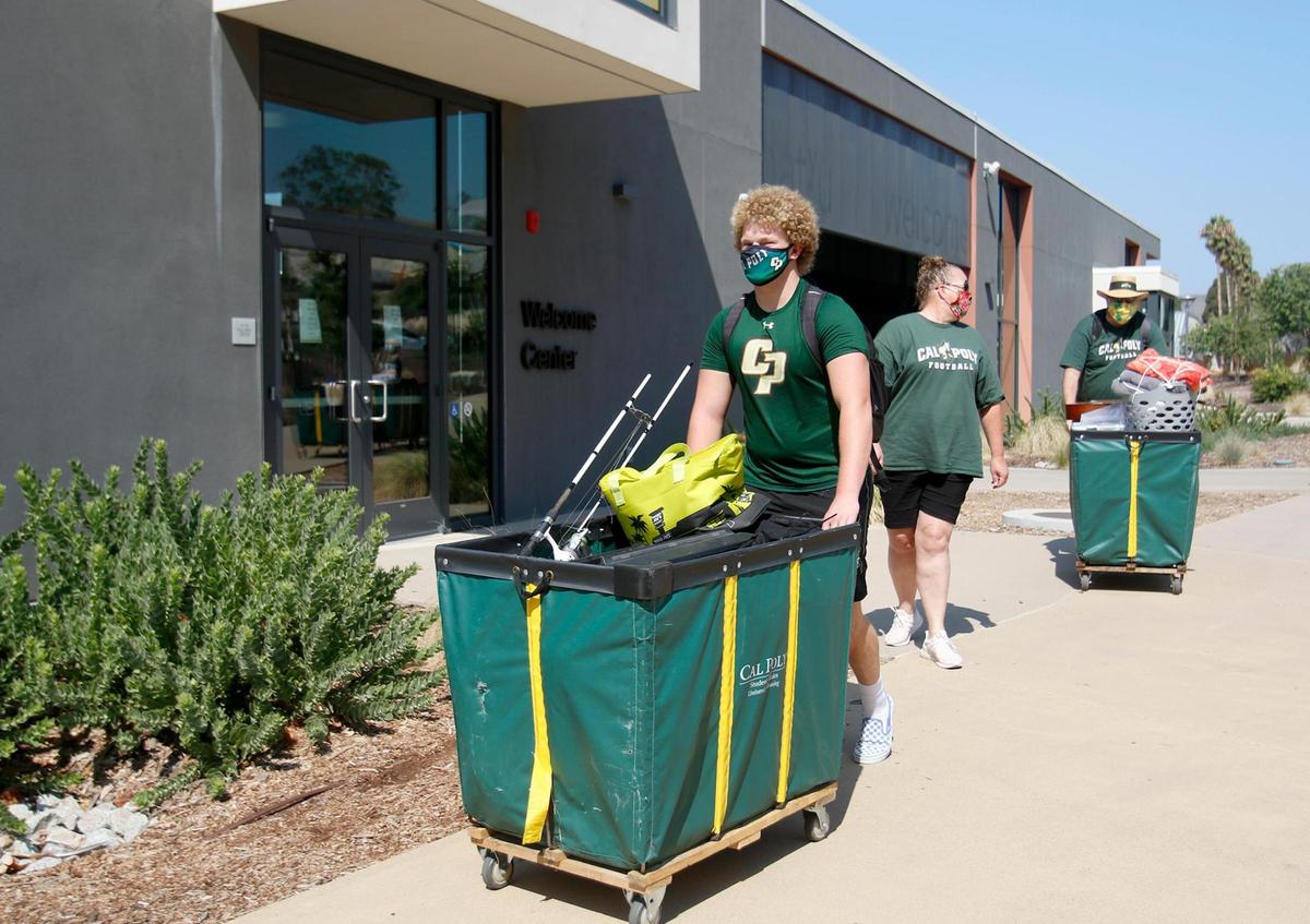 On the first day of move-in, Sept. 3, mechanical engineering major Austin Anderson of San Ramon pushes a load of his belongings to his dorm at Cal Poly with the help of his parents.