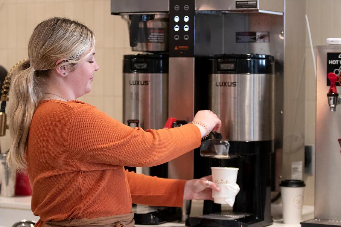 Barista Ashley Wiese pours a hot cup of coffee at the new Scout Coffee location that opened Tuesday, Feb. 21, 2024, in Morro Bay.