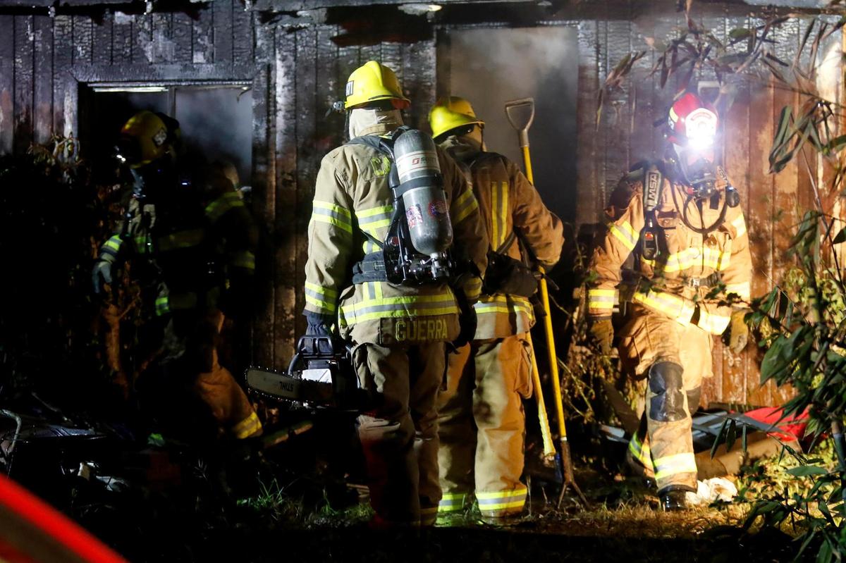 Firefighters enter the building after knocking down the flames. Cal Fire crews are responded to reports of a fully-engaged house fire on 7th Street in Los Osos.