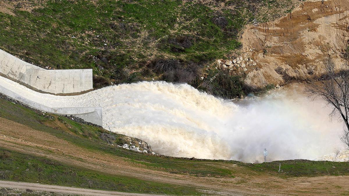 Water spills from Lake Nacimiento on Jan. 20, 2023, after the atmospheric river storms dumped billions of gallons of water into the reservoir.