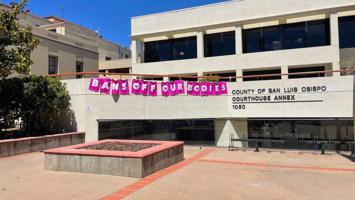 A banner that reads “BANS OFF OUR BODIES” hangs from the county’s courthouse during the Planned Parenthood march on Saturday, May 14, 2022.