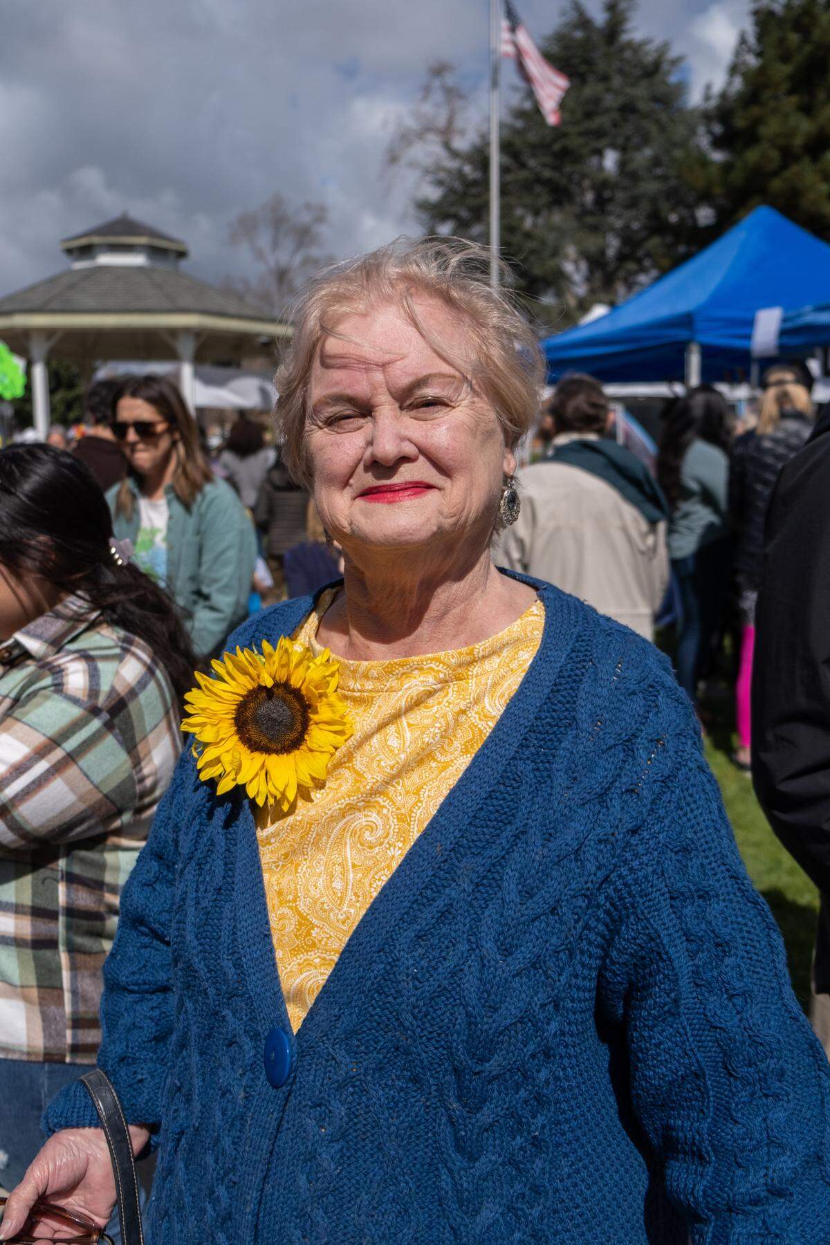Sandra Mathias poses in her yellow and blue outfit at the Engage for Equity Rally in San Luis Obispo on March 5, 2022.