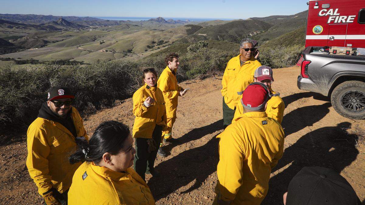 Cultural burn practitioner Kelsey Shaffer, center, coordinates plans for a cultural burn led by the yak titʸu titʸu yak tiłhini Northern Chumash Tribe. The burn was originally scheduled for the Miossi Open Space, seen here, but was moved to the Johnson Ranch Open Space due to unfavorable winds on Dec. 11, 2025.