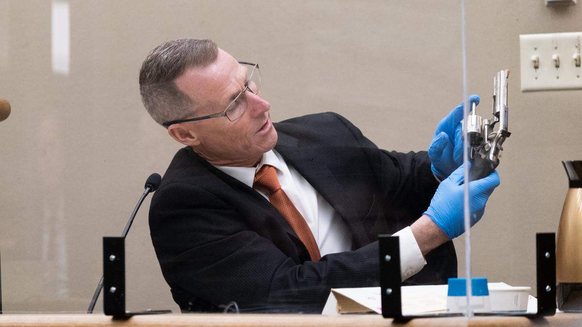 San Luis Obispo County District Attorney’s Office investigator Paul Kelly shows the jury hearing the case against Stephen Deflaun the .357 Magnum revolver that was allegedly used in the shooting, in San Luis Obispo Superior Court on April 10, 2023.