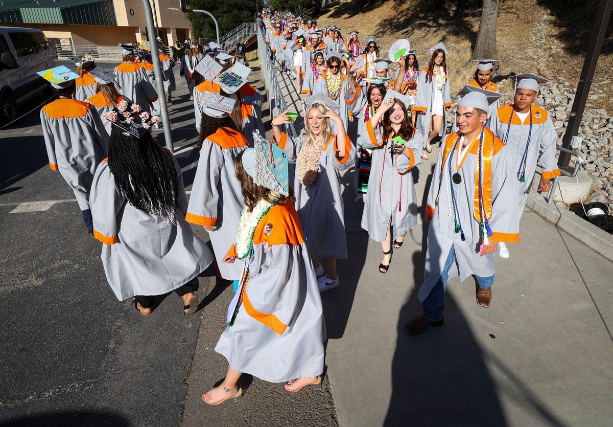 Students walk to the football stadium as Atascadero High School celebrated the graduation of 261 students June 6, 2024.